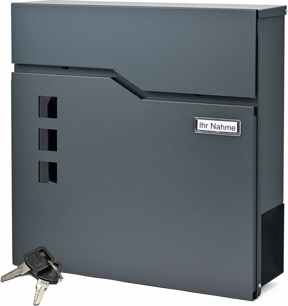 A dark gray mailbox with a newspaper compartment and keys in the foreground.