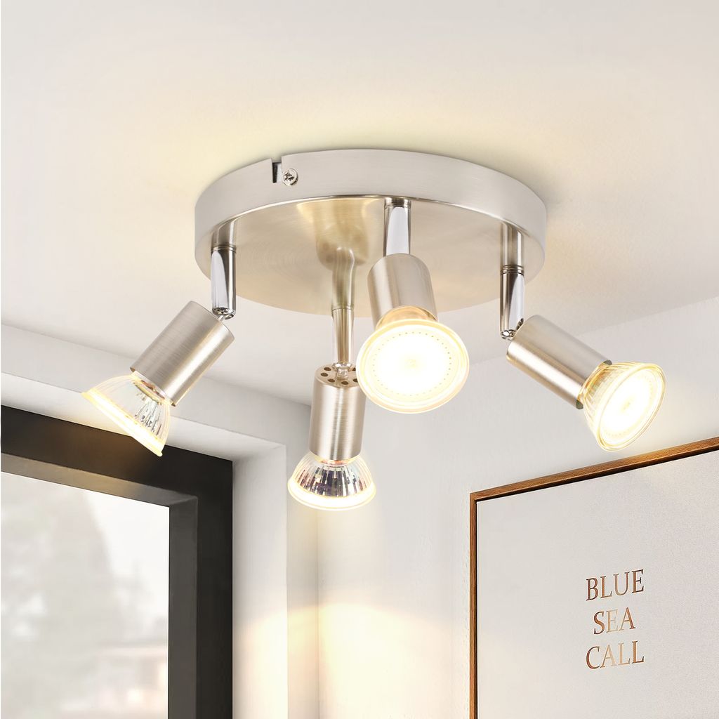 A ceiling light fixture with four adjustable spotlights is shown against a white ceiling.