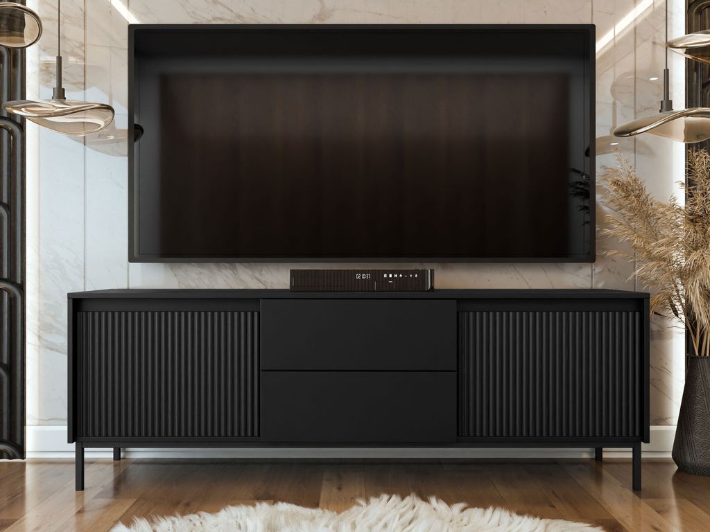 A black TV stand with a large television mounted above it, in a modern living room setting.