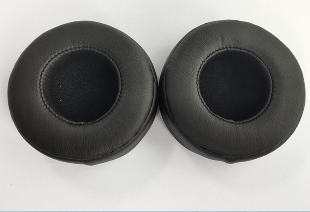 Two black headphone ear pads are shown on a white background.