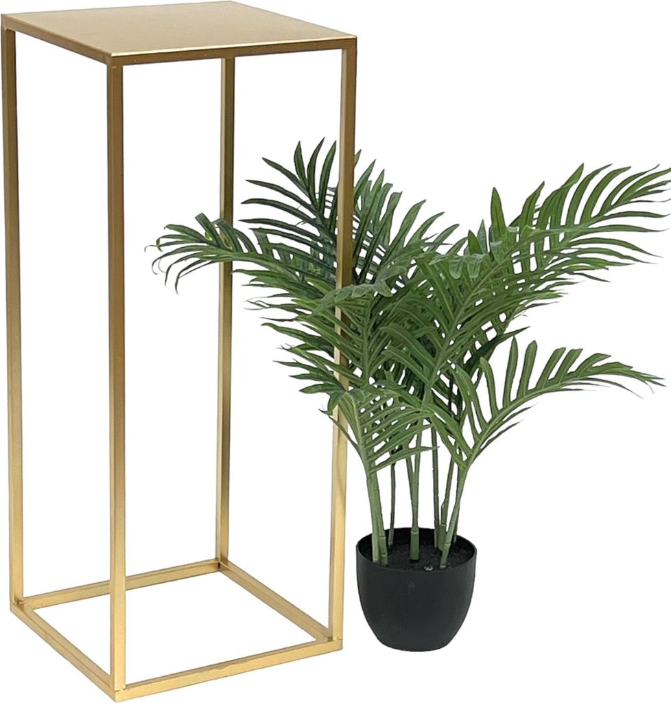 A gold metal plant stand next to a potted green plant.