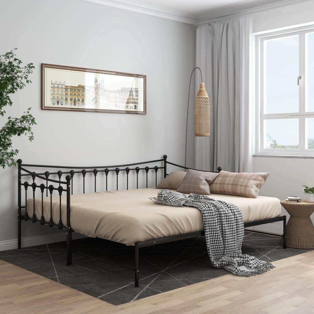 A bedroom scene with a daybed, pillows, and a blanket.