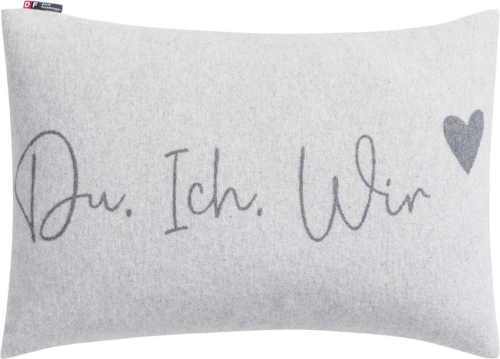 A light gray pillow with the text "Du, Ich, Wir" and a heart graphic.