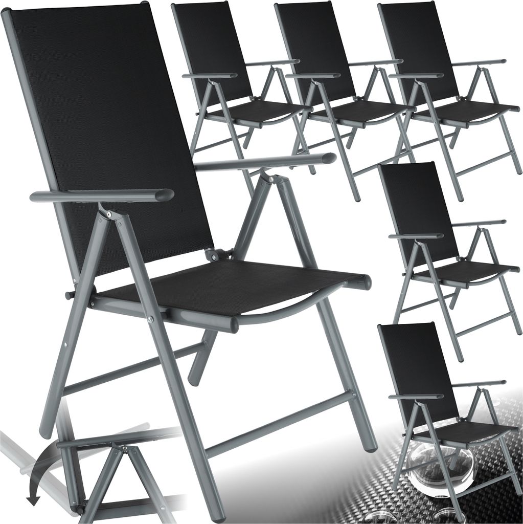 Multiple black folding chairs are arranged in a studio setting against a white background.