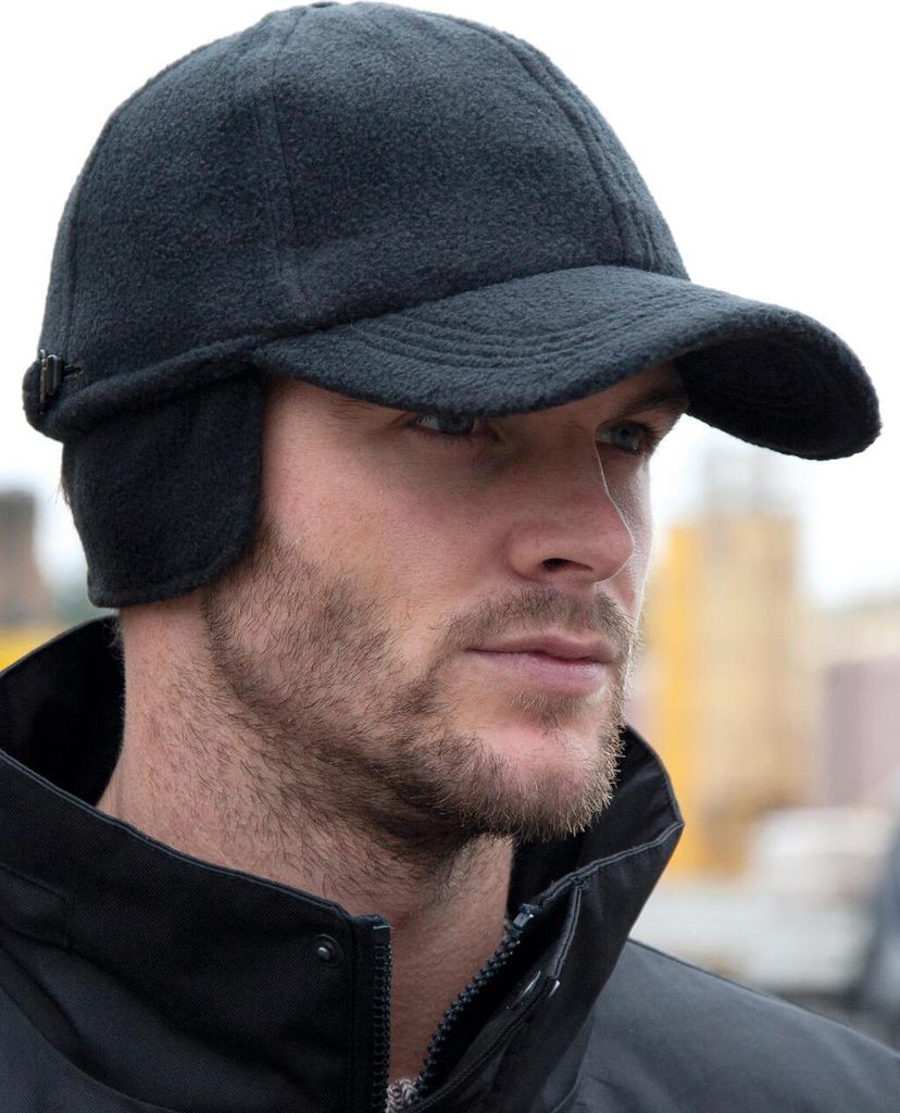 A man wearing a black fleece cap with ear flaps.