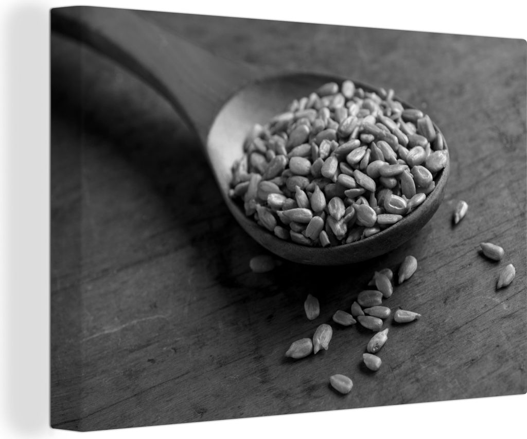 OneMillionCanvasses - Leinwandbilder - 140x90 cm, Holzlöffel voll mit Sonnenblumenkernen auf einem Holztisch - schwarz-weiß, Wandbilder Kunstdr...