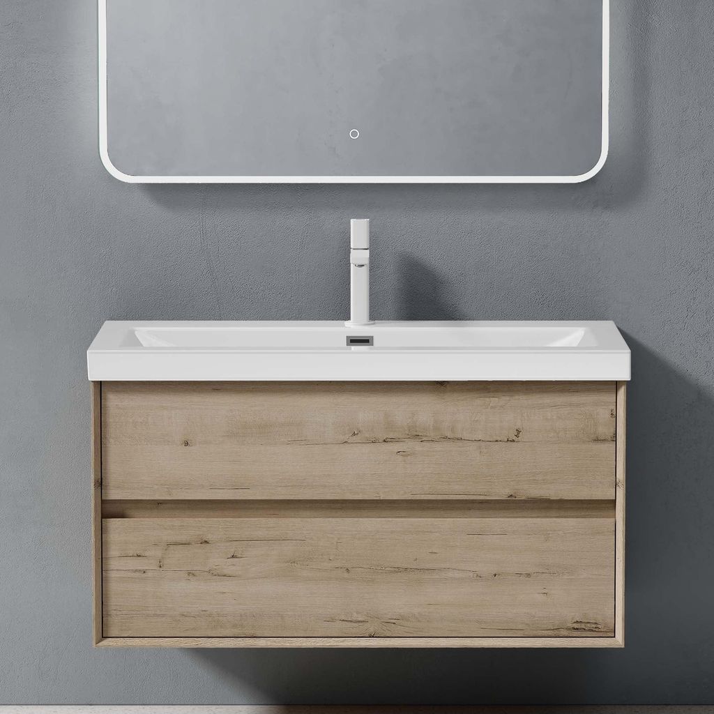 A modern wall-mounted bathroom vanity with a sink and faucet, against a grey wall.