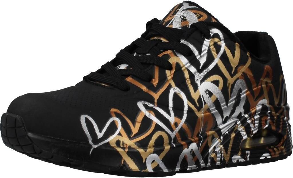 A single black sneaker with a metallic heart pattern is shown against a white background.