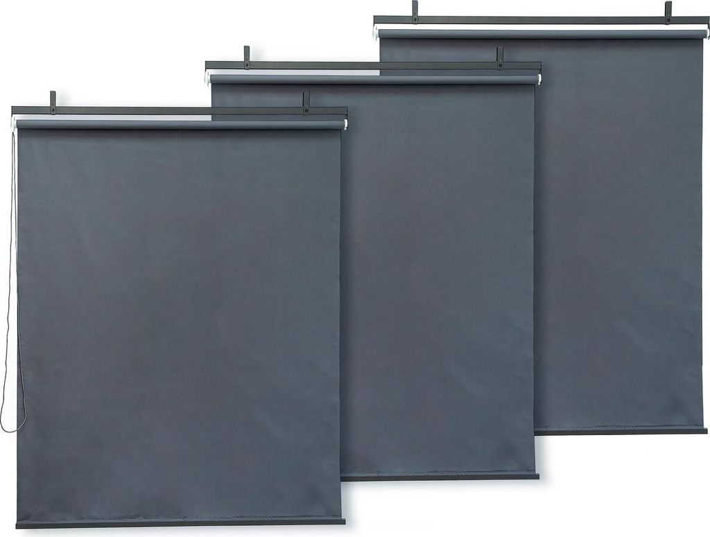 Three dark gray roller blinds are displayed side-by-side, with the leftmost blind being the widest and the rightmost being the narrowest.