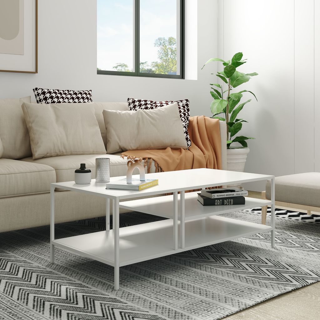A modern living room scene with a couch, coffee table, and rug.