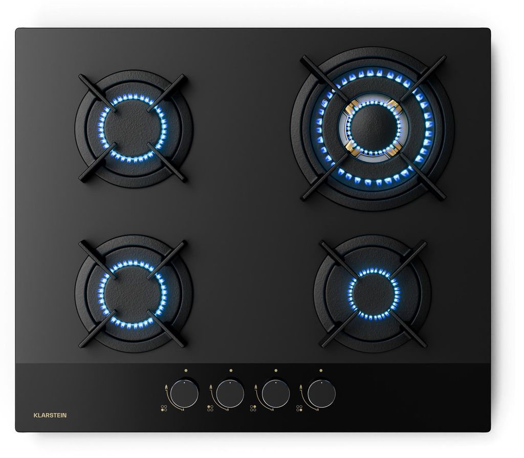 A top-down view of a black gas stovetop with four burners, three of which are lit with blue flames.