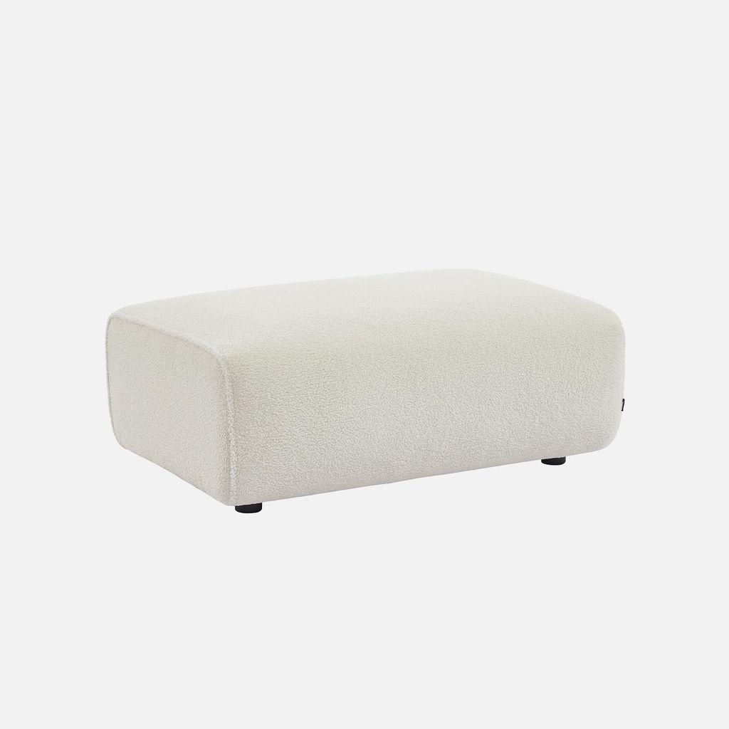 A cream-colored bouclé ottoman is shown against a plain white background.