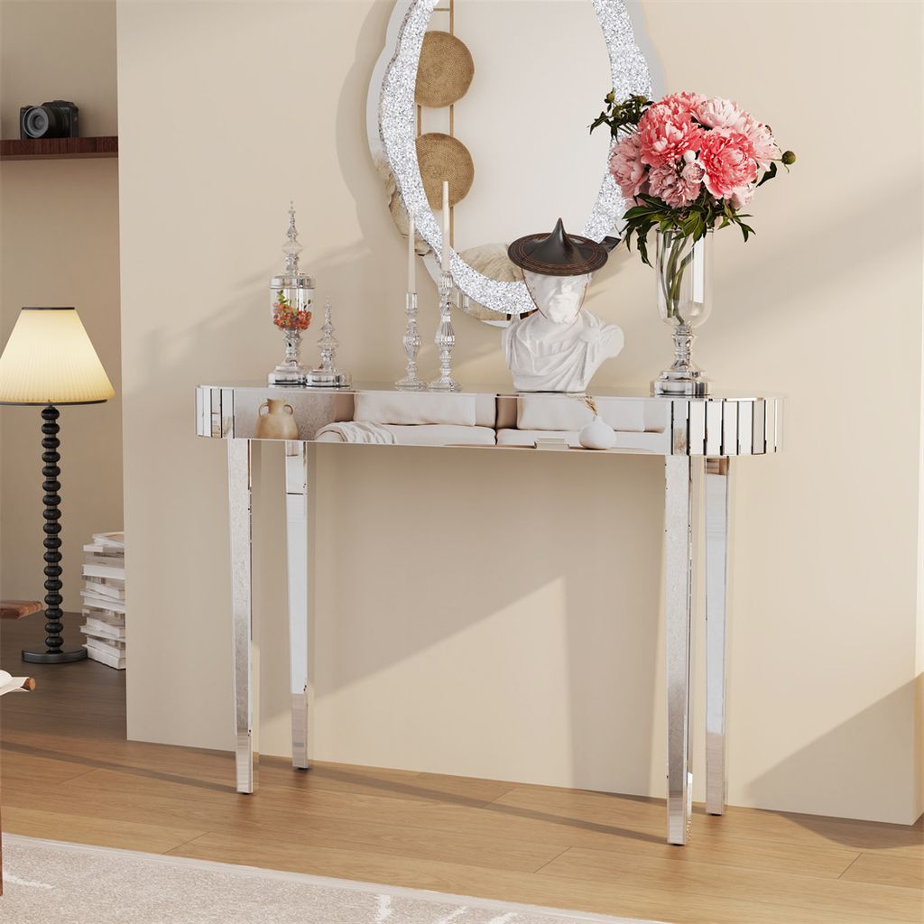 A mirrored console table with decorative items in a hallway.