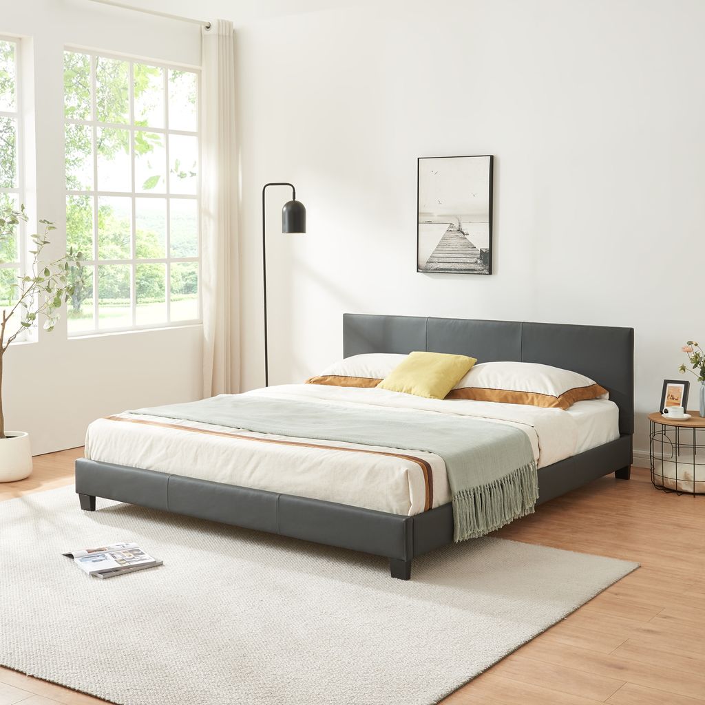 A bedroom scene with a bed, lamp, and window.