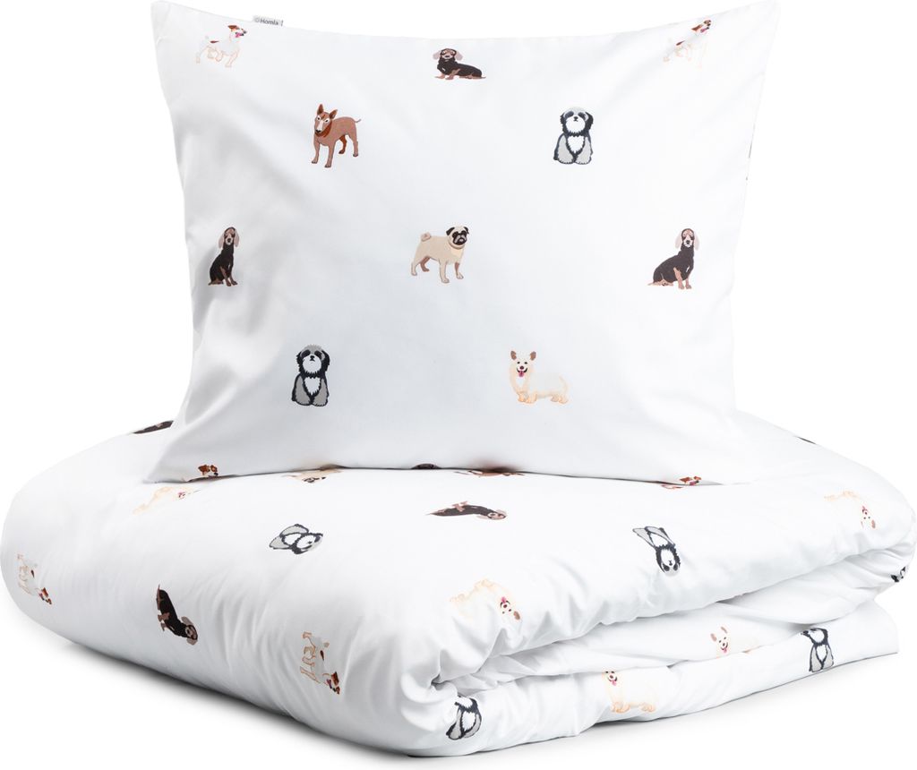 A folded duvet and pillow with a pattern of various dog breeds on a white background.