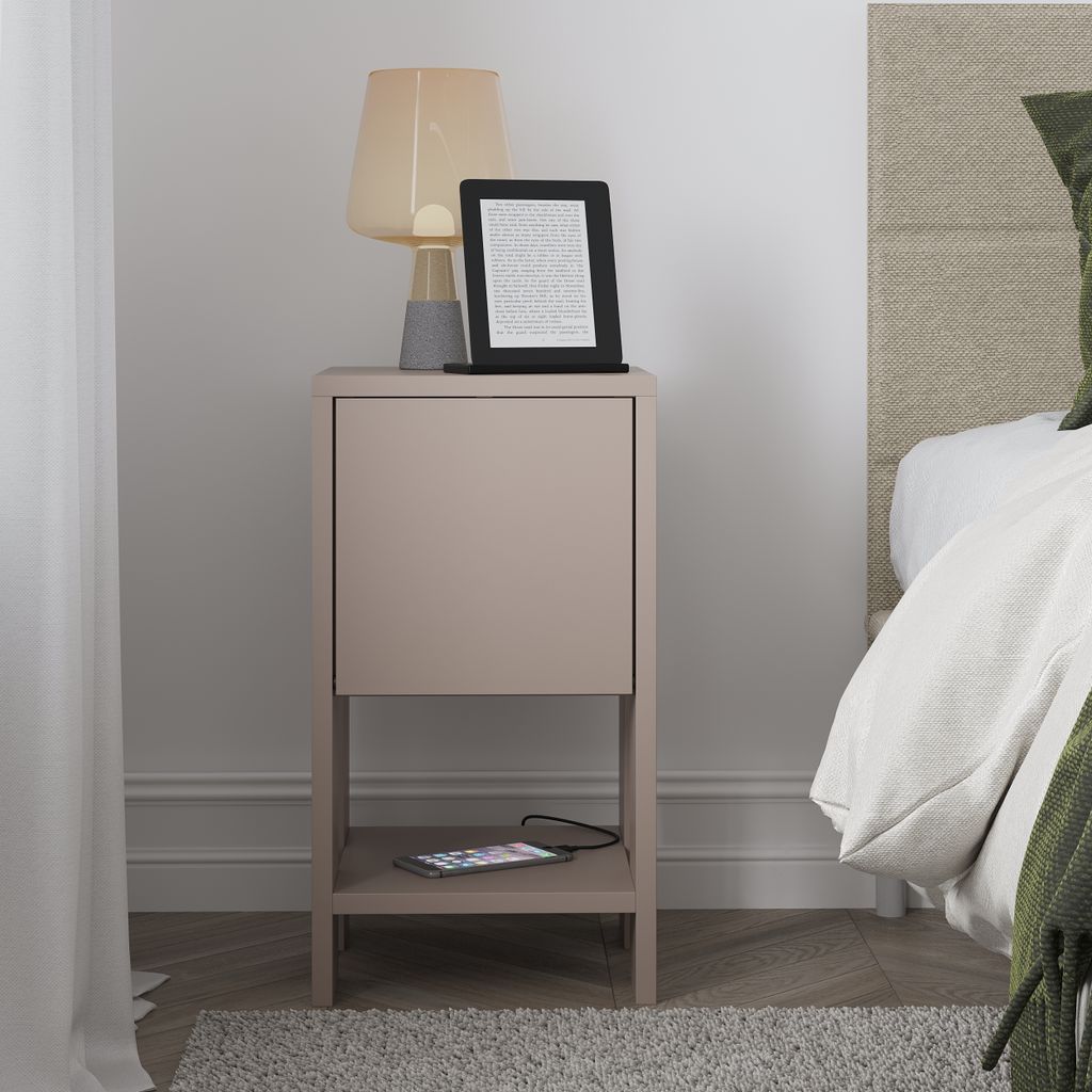A bedside table with a lamp, e-reader, and phone.