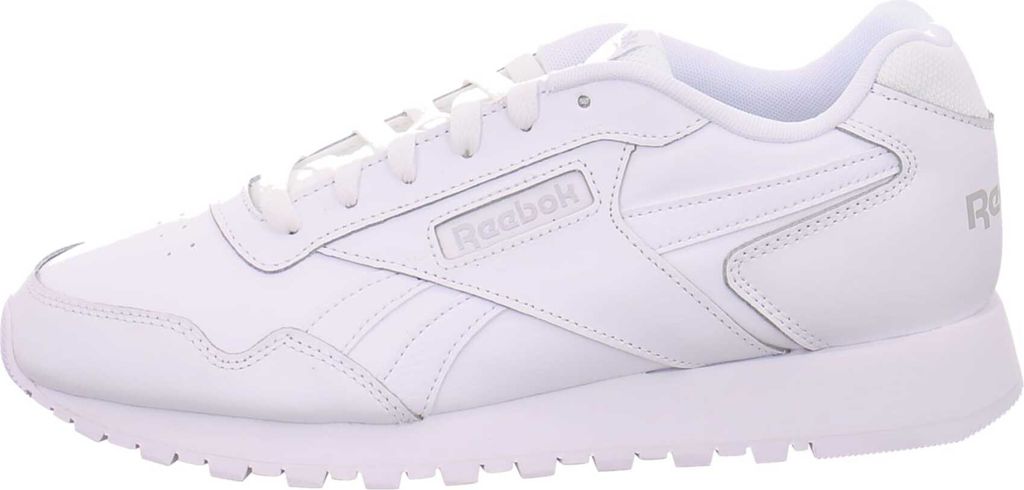 A side view of a white Reebok sneaker.