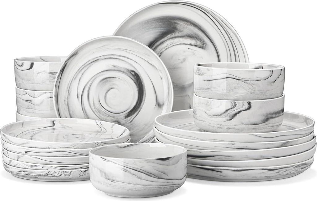 A collection of marble-patterned ceramic dinnerware, including plates and bowls, arranged on a white background.