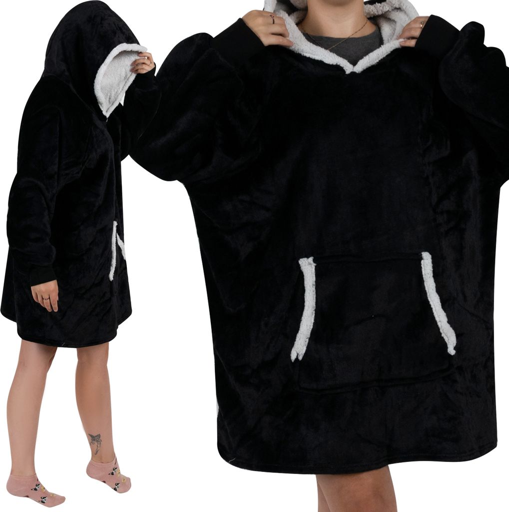 A person wearing a black oversized hoodie with a light gray lining.