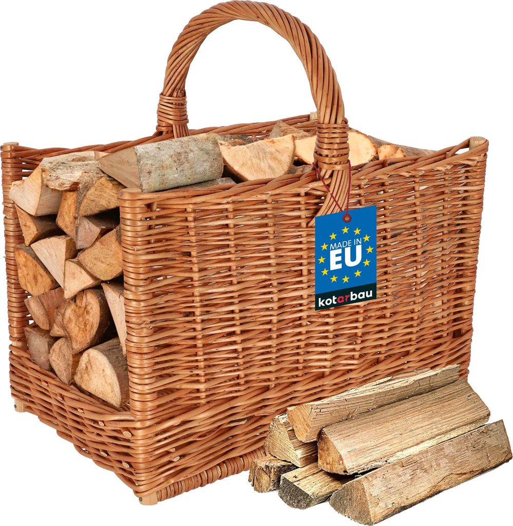 A woven basket filled with firewood, with some firewood pieces in front of the basket.