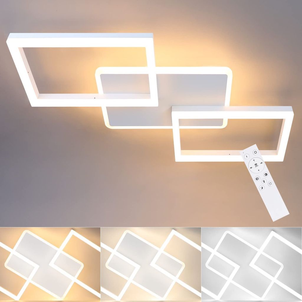 A modern white LED ceiling light with a geometric design, shown on a light gray ceiling. A remote control is also visible.
