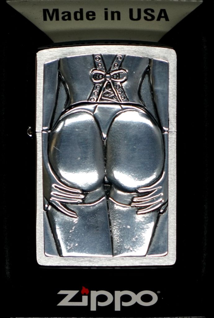 A Zippo lighter with a raised design of a woman's buttocks and lingerie, with the 'Made in USA' text above and the Zippo logo below.
