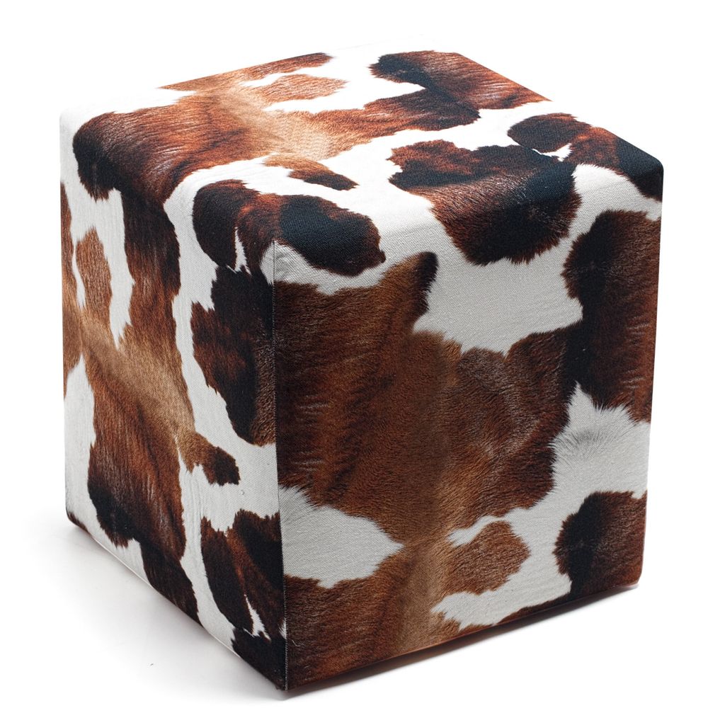 A cube-shaped ottoman with a cowhide pattern.