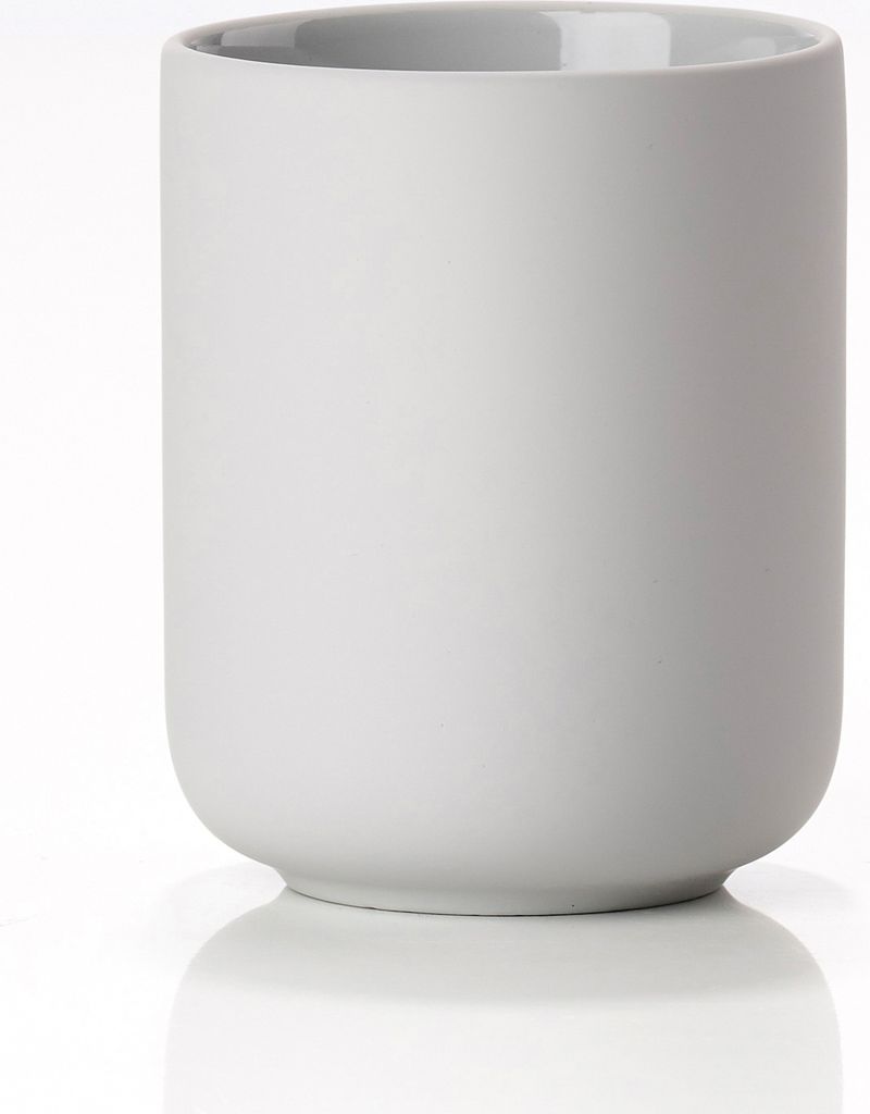 A studio shot of a soft grey ceramic toothbrush holder on a white background.