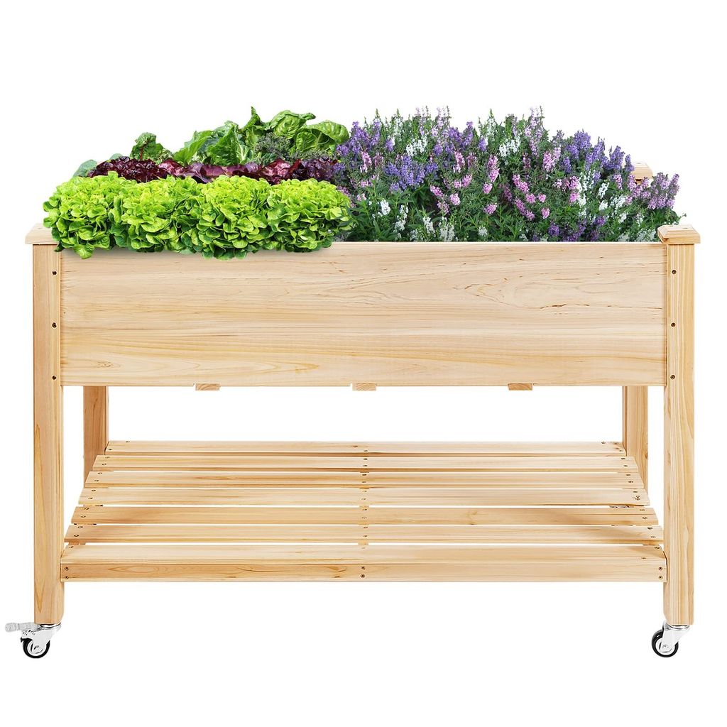 A wooden raised garden bed filled with various plants and flowers, placed on a white background.