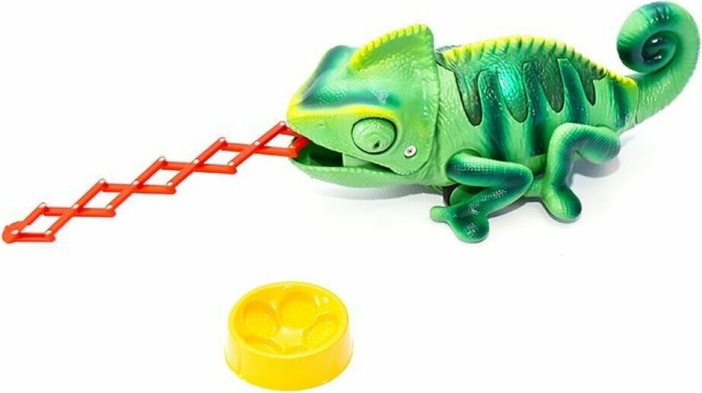 A green toy chameleon with its tongue extended, next to a yellow bowl, on a white background.