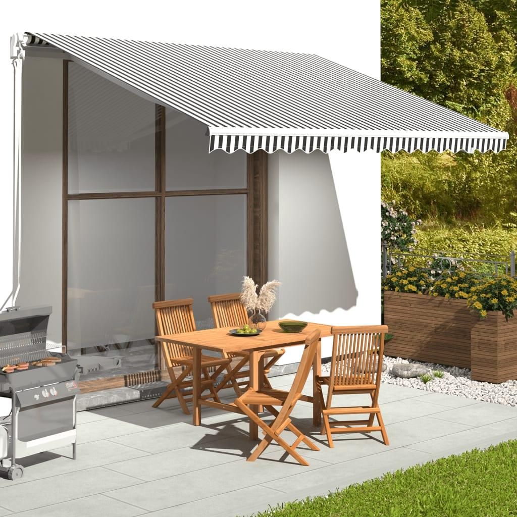 An outdoor patio scene with a table, chairs, and a grill under an awning.