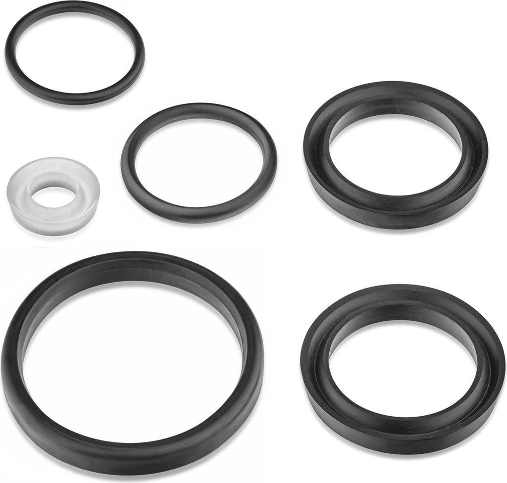 A collection of black and one white rubber rings or gaskets laid out on a white background.