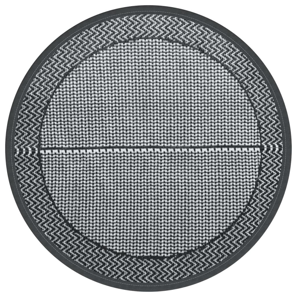 A circular outdoor rug with a geometric pattern.