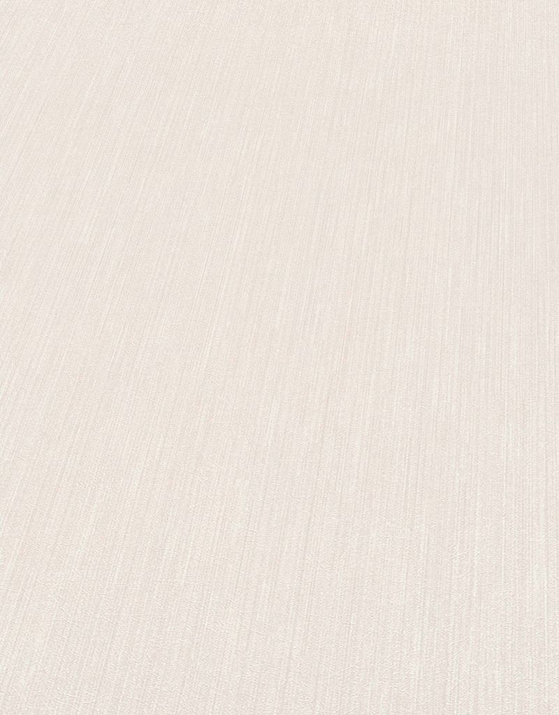 A close-up, angled view of a textured, cream-colored wallpaper.