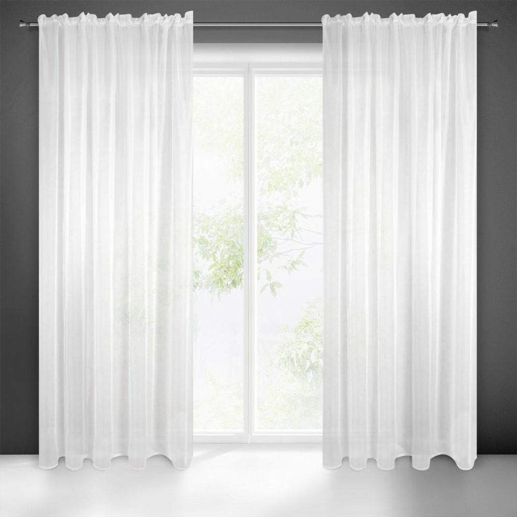 A pair of white sheer curtains hanging in front of a window.
