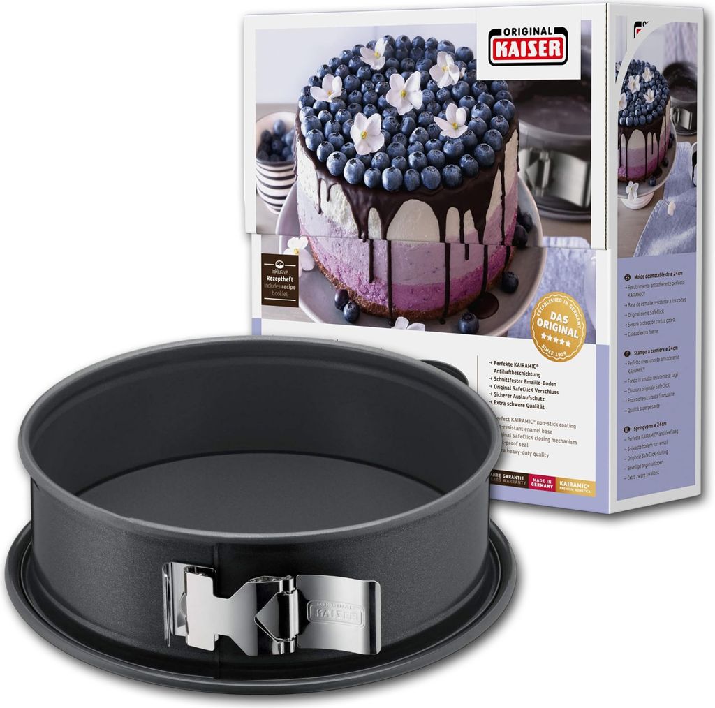 A springform pan is shown in the foreground, with its packaging in the background. The packaging displays a picture of a cake made in the pan.
