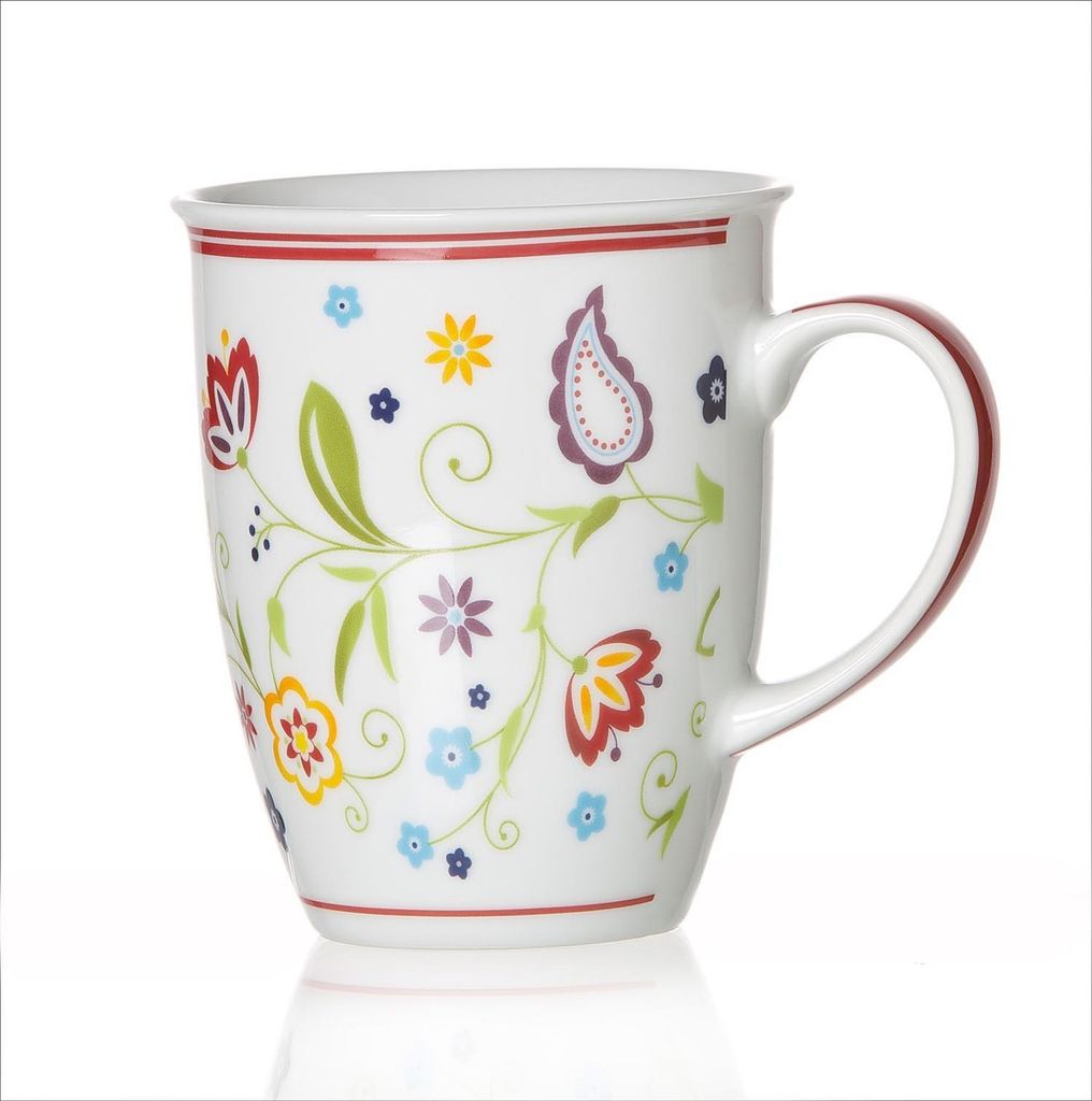 A white ceramic mug with a floral pattern and a red rim, isolated on a white background.