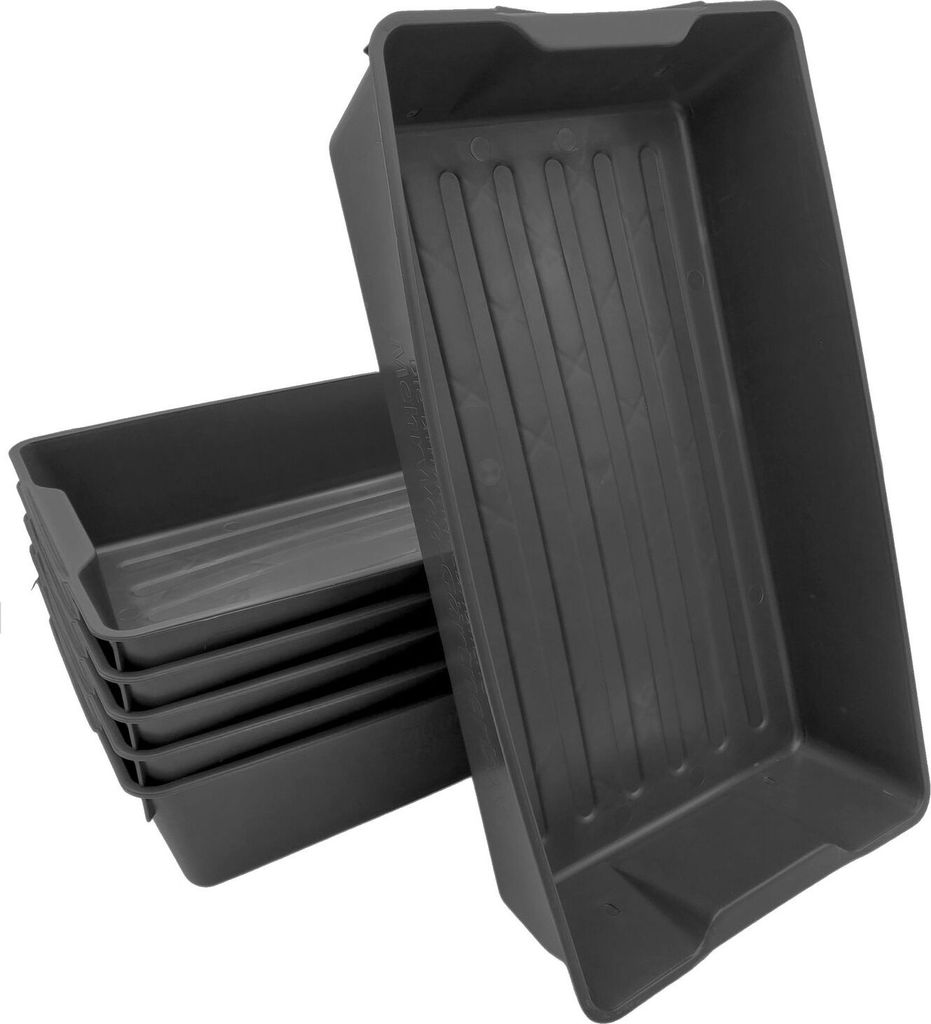 A stack of dark gray planting trays.
