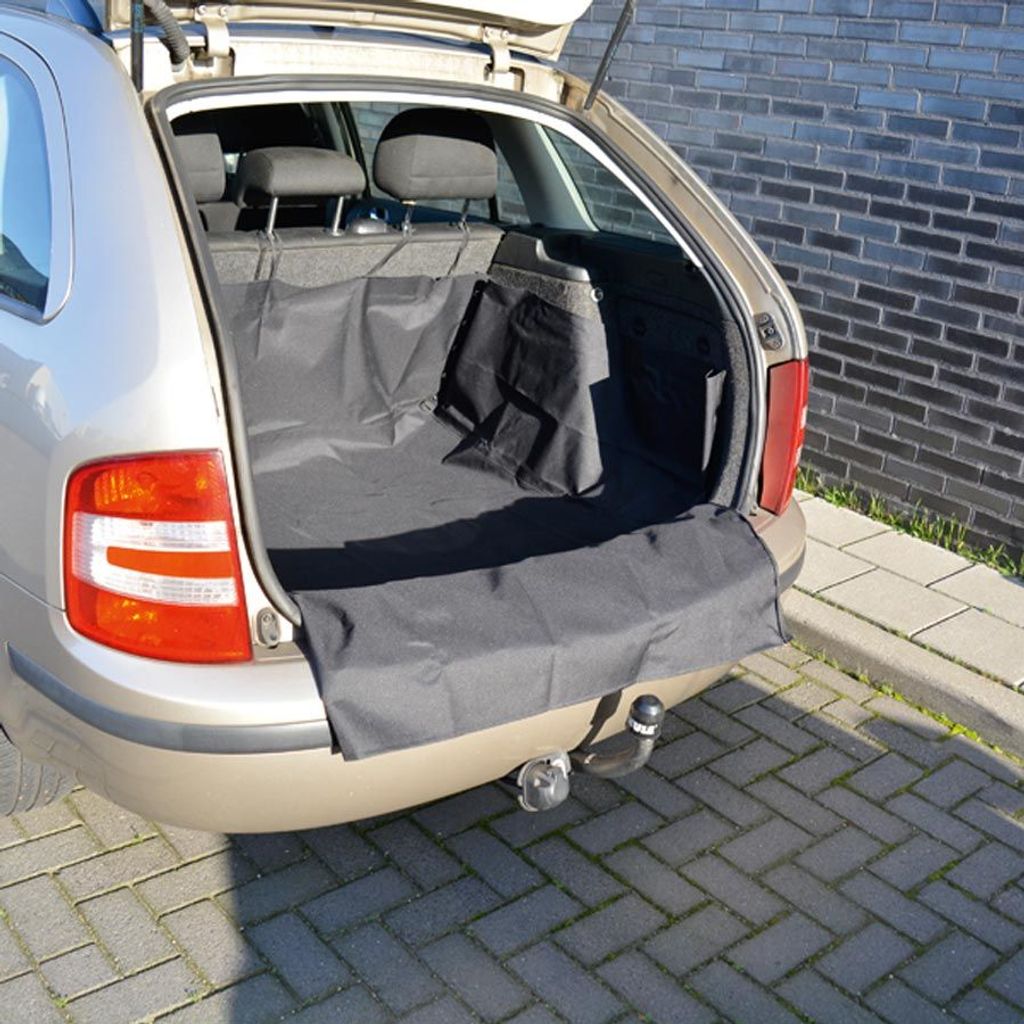 The open trunk of a car with a black protective mat installed.