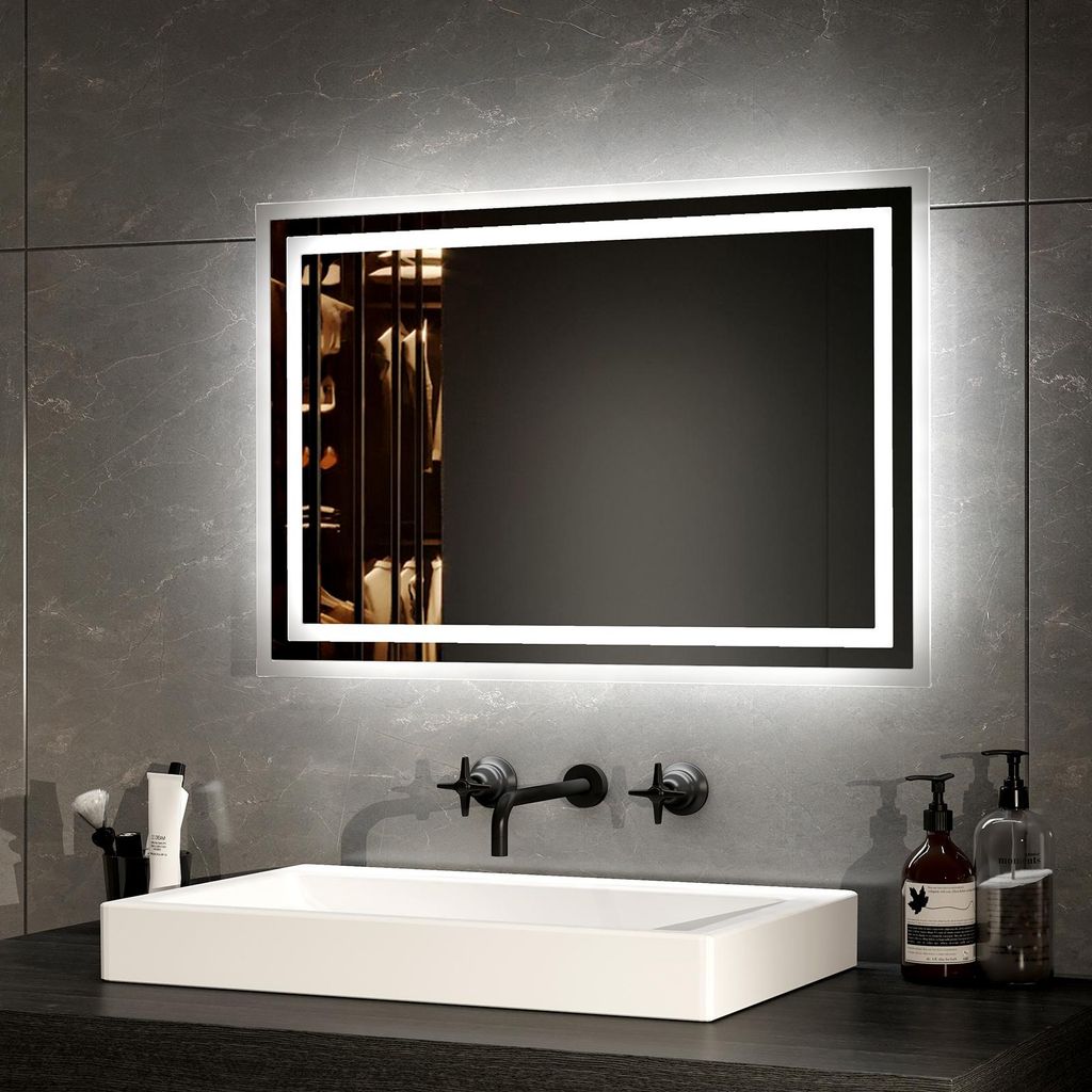 A modern bathroom vanity with a sink, faucet, and an illuminated mirror.