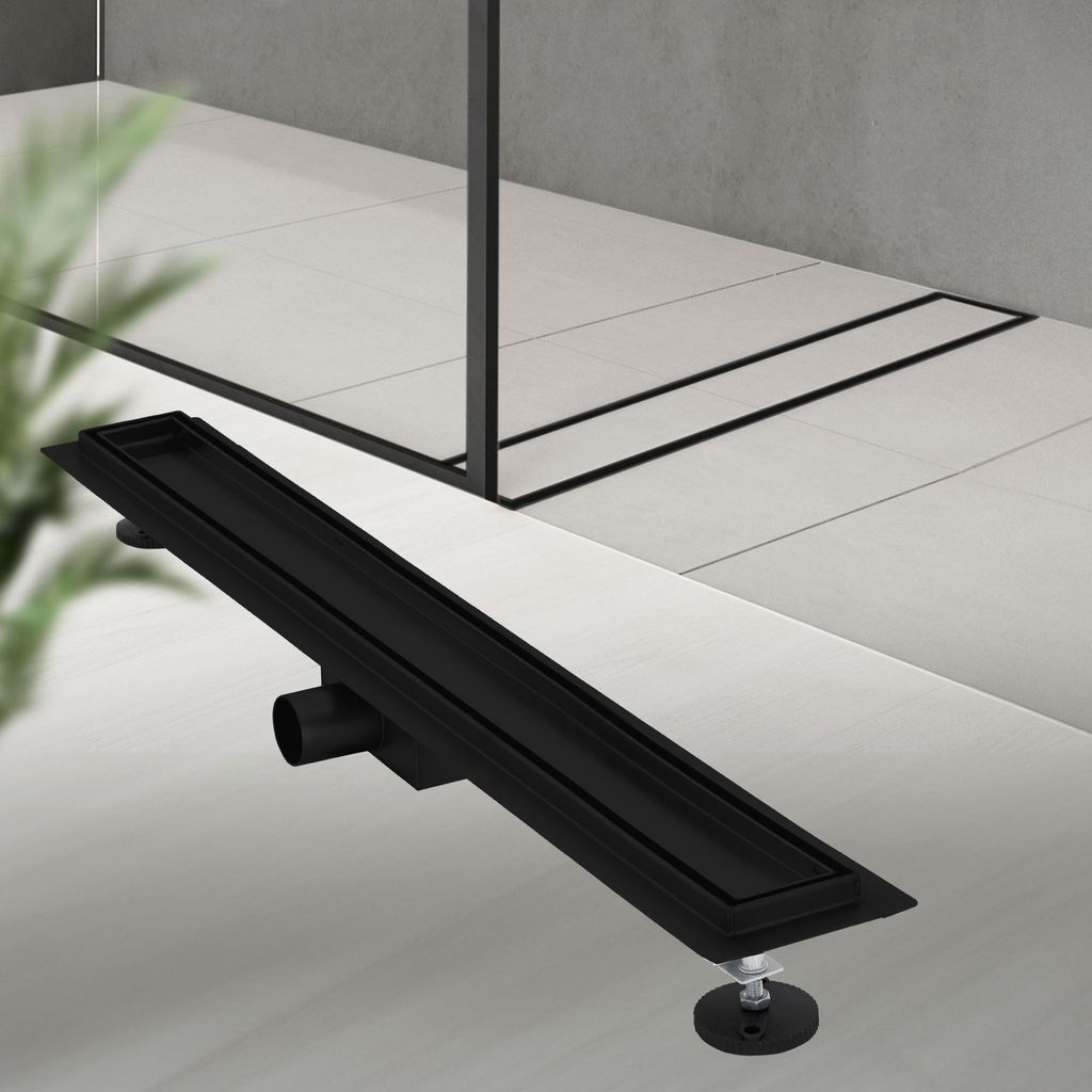 A black linear shower drain is shown on a tiled floor.