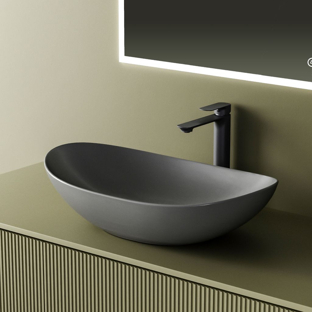 A modern bathroom sink with a matte gray finish and a black faucet, set against a pale green wall and a textured cabinet.