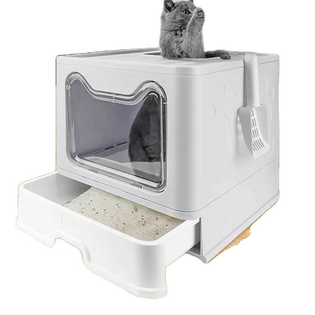 A grey cat is peeking out of a white litter box with a pull-out drawer.