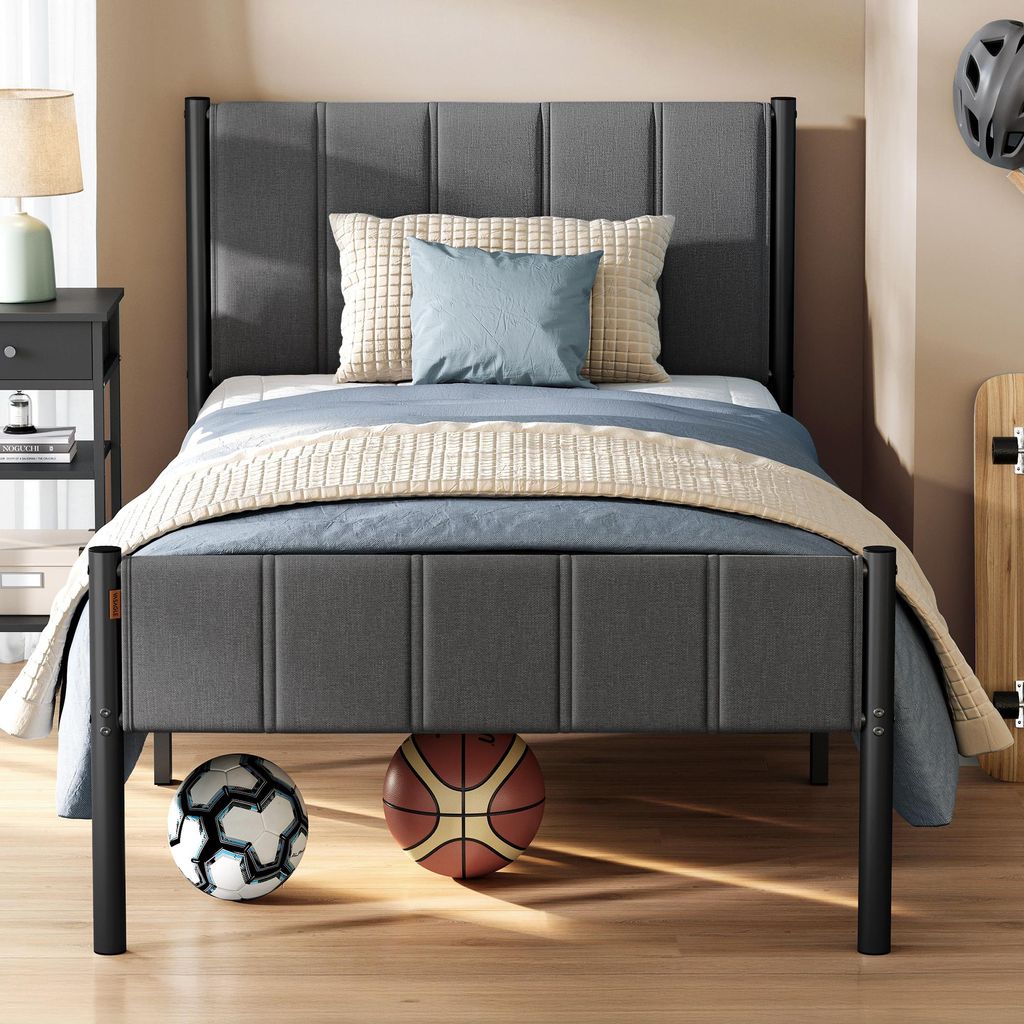 A bedroom setting with a bed, nightstand, and sports equipment.