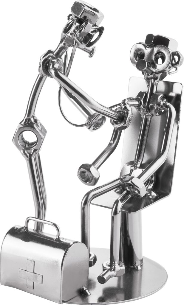 A metal sculpture of a doctor examining a patient, with a medical bag nearby.