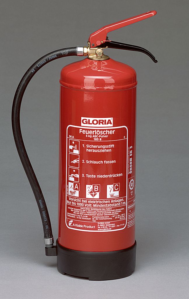 A red fire extinguisher with a black hose and base, set against a plain gray background.