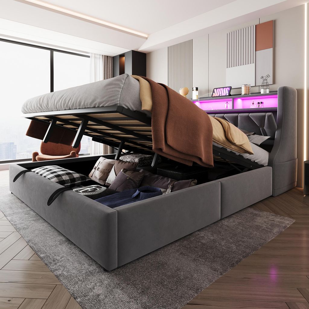 A bedroom with a large storage bed with its lift-up mechanism open, revealing stored items. The bed has LED lighting.