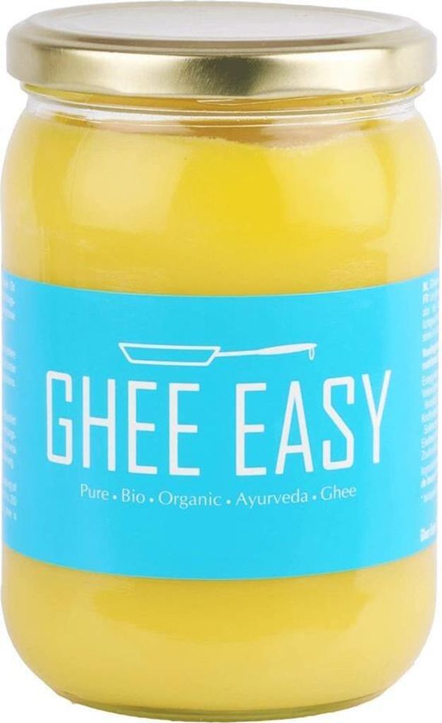 A glass jar of ghee with a blue label.