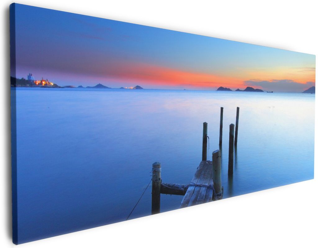 Wallario Premium Leinwandbild Steg im Wasser - Abendstimmung am Meer in Größe 50 x 125 cm
