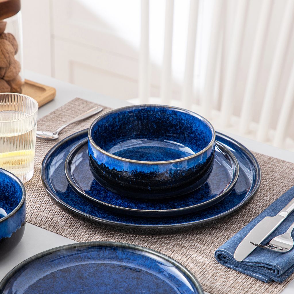 A close-up view of a set of blue ceramic dishes arranged on a table.
